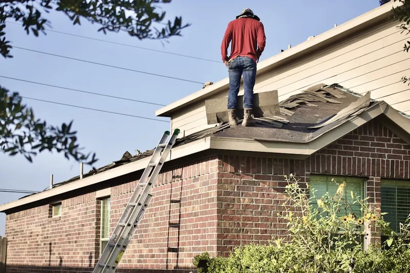 Professional roofer working on a residential roof in Linnton